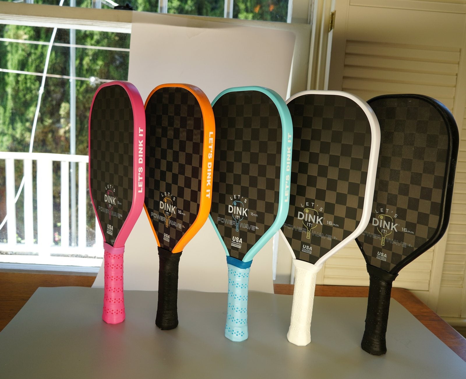 Figureology paddles displayed by a window